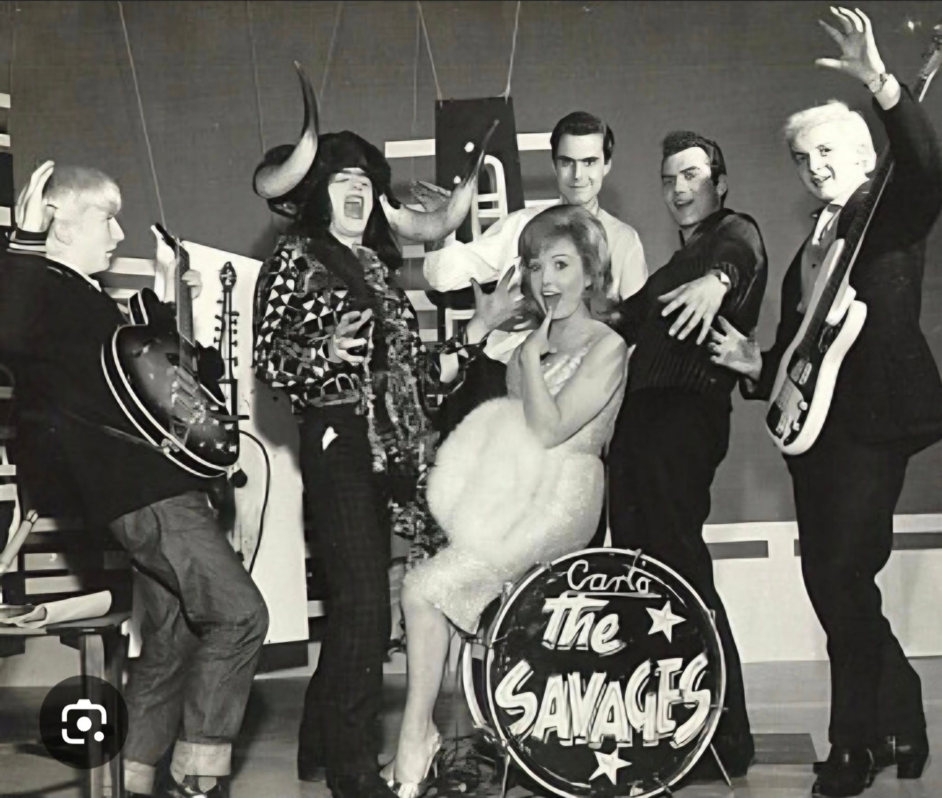 The Savages posing with instruments in a 1960s TV studio set