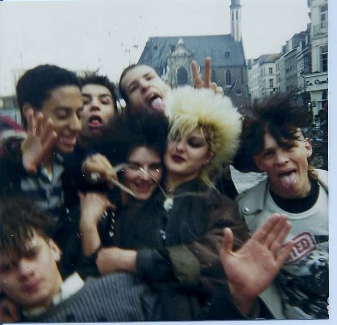 Belgian punks pulling faces for the camera on a city square, early 1980s